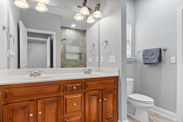 bathroom featuring tile patterned flooring, toilet, tiled shower, and a sink