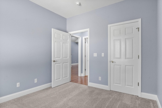 unfurnished bedroom featuring baseboards and carpet floors