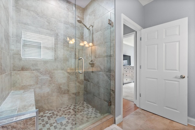 bathroom with tile patterned floors and a shower stall