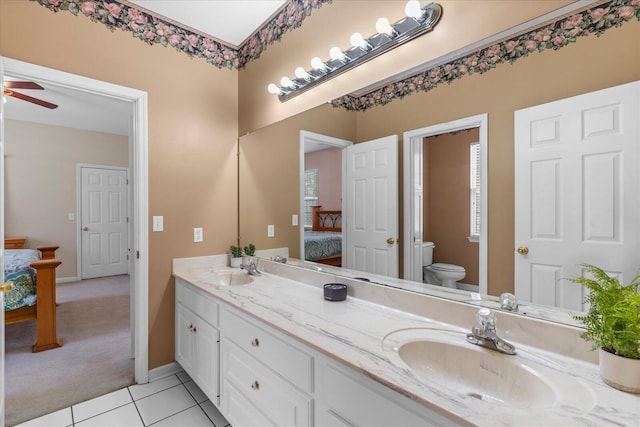 ensuite bathroom with a sink, toilet, double vanity, and ensuite bathroom