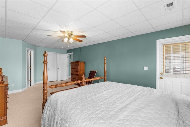 bedroom with visible vents, a ceiling fan, carpet, a paneled ceiling, and baseboards