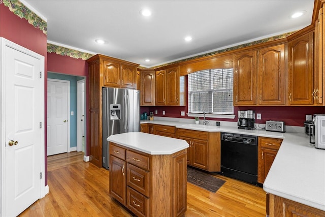 kitchen with black dishwasher, light wood-style floors, stainless steel refrigerator with ice dispenser, and a sink