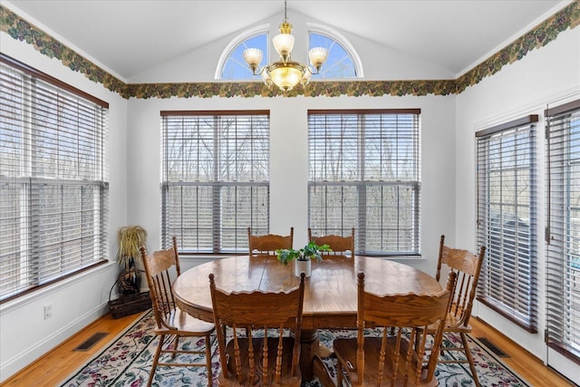 dining area with light wood-type flooring, visible vents, plenty of natural light, and a chandelier