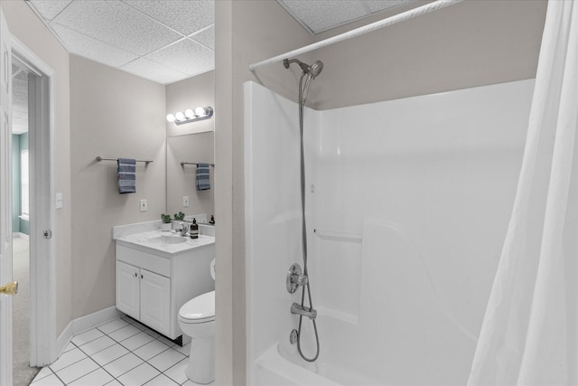 full bathroom featuring vanity, shower / bath combo, a drop ceiling, tile patterned floors, and toilet