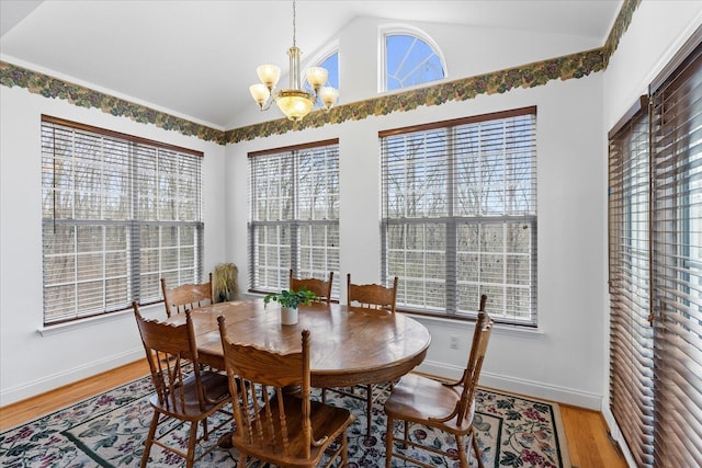 dining space featuring baseboards, light wood-style floors, an inviting chandelier, and vaulted ceiling