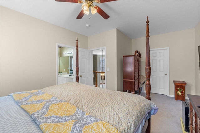 bedroom featuring a ceiling fan, ensuite bath, light colored carpet, and baseboards