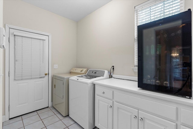 washroom with light tile patterned floors and washer and dryer