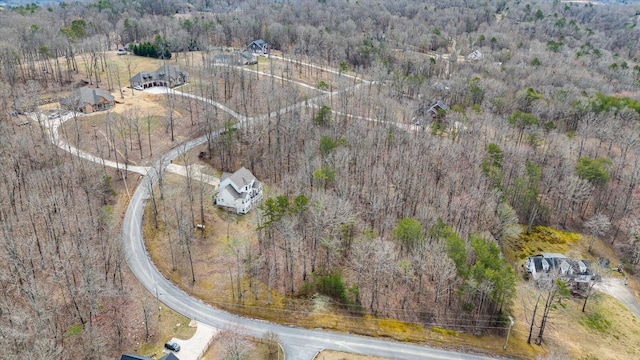 birds eye view of property featuring a view of trees