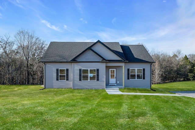 view of front of property with a front lawn and a shingled roof