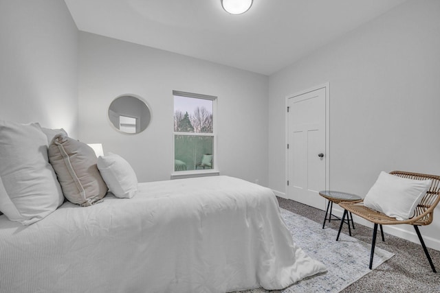 bedroom featuring baseboards and carpet