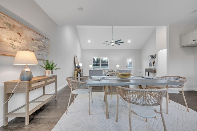 dining area featuring ceiling fan, dark wood-type flooring, baseboards, and vaulted ceiling