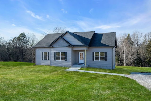 view of front facade with a front lawn and roof with shingles