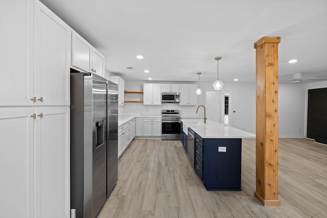 kitchen with recessed lighting, light wood-style floors, appliances with stainless steel finishes, white cabinets, and light countertops