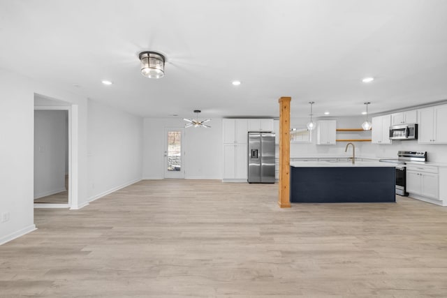 kitchen featuring open shelves, appliances with stainless steel finishes, light wood-style flooring, and light countertops