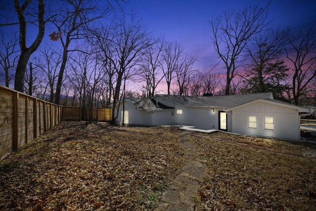 view of home's exterior with board and batten siding and fence