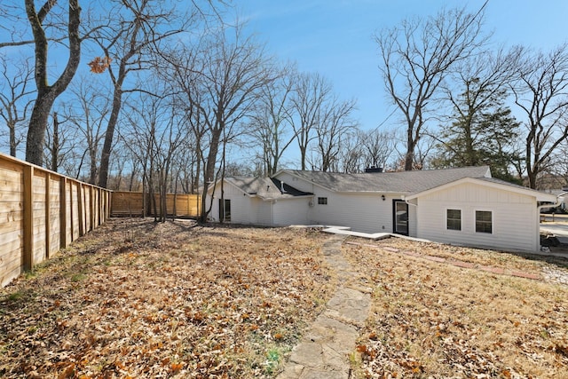 exterior space featuring board and batten siding and fence