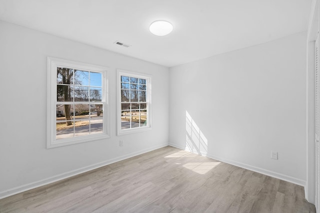 unfurnished room with visible vents, baseboards, and light wood-style floors