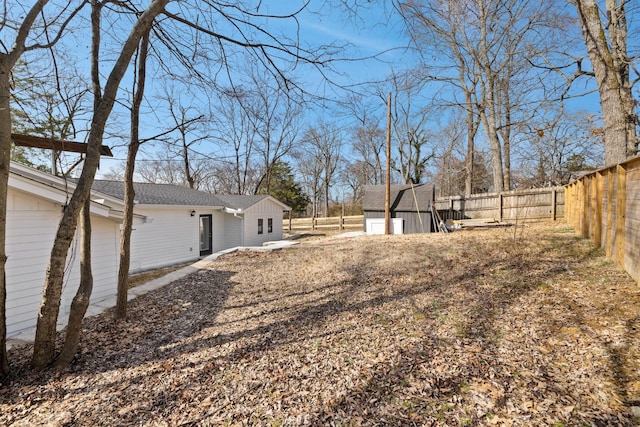 view of yard featuring an outbuilding and a fenced backyard