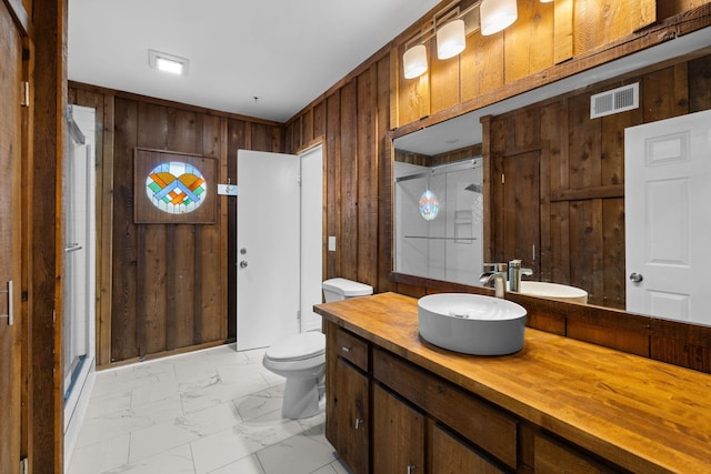 full bathroom featuring a shower stall, visible vents, marble finish floor, and wood walls