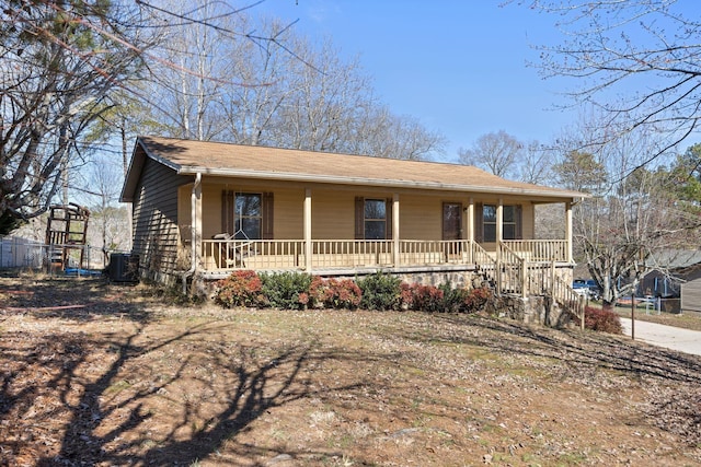 view of front facade featuring a porch and central AC