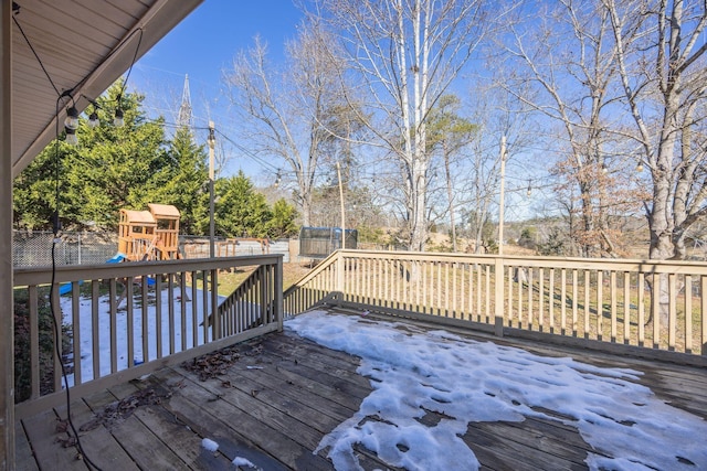 wooden terrace with fence and a playground