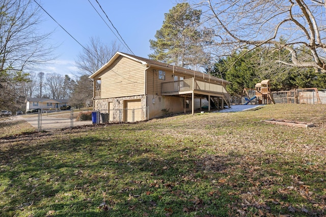 exterior space with stairway, fence, a wooden deck, a yard, and a playground