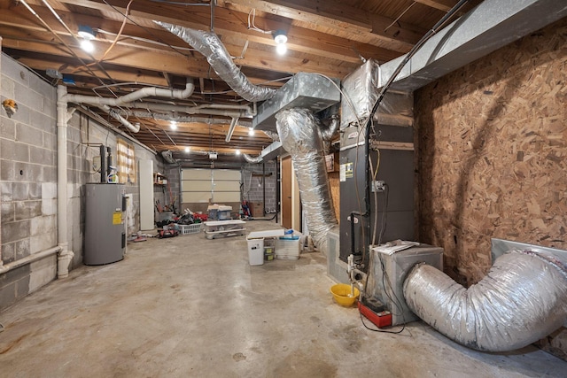 interior space featuring electric water heater and concrete block wall