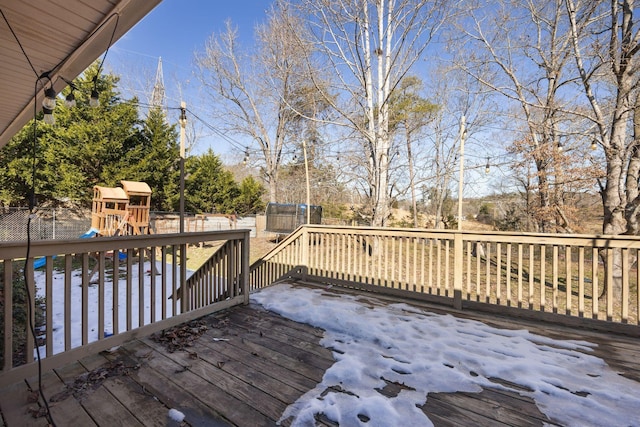 deck with a playground, a trampoline, and fence