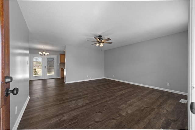 unfurnished room featuring dark wood-style floors, visible vents, baseboards, french doors, and ceiling fan with notable chandelier