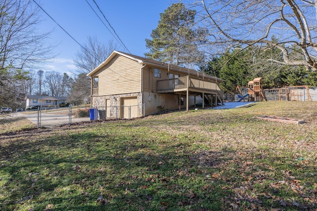 view of side of property featuring fence, a wooden deck, a yard, stairs, and a playground