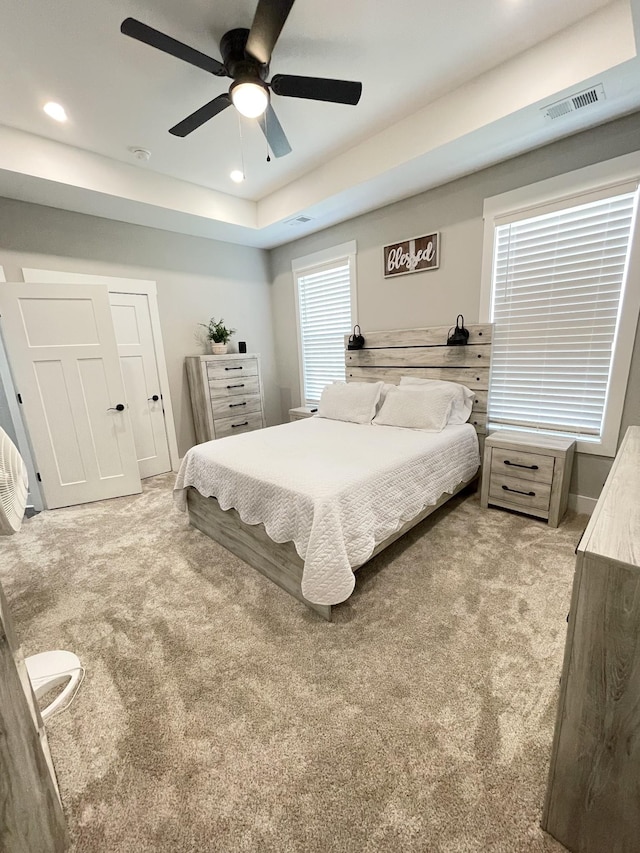 bedroom with recessed lighting, light colored carpet, and visible vents