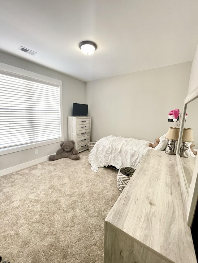 bedroom with visible vents, carpet flooring, and baseboards