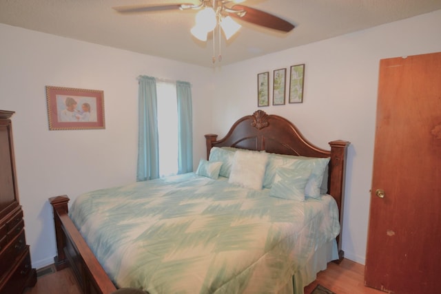 bedroom featuring wood finished floors and a ceiling fan