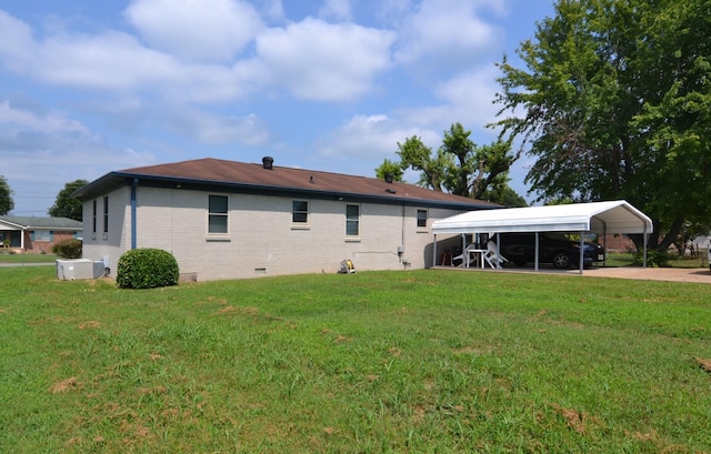 exterior space with ac unit, a lawn, a detached carport, and brick siding