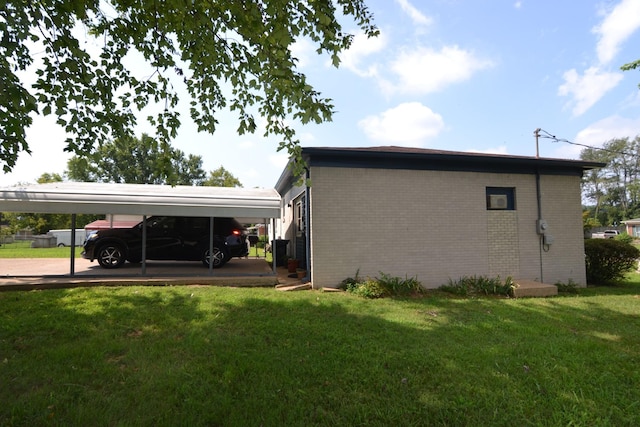 view of home's exterior featuring a carport, a lawn, and brick siding