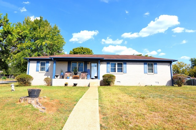 ranch-style house featuring a front lawn, a porch, brick siding, and crawl space