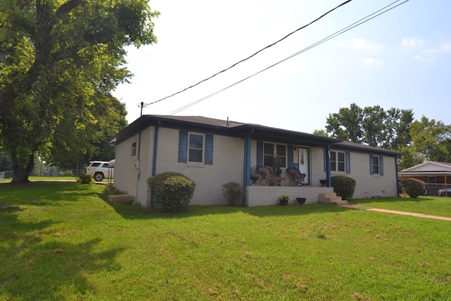 ranch-style house featuring crawl space, brick siding, and a front yard