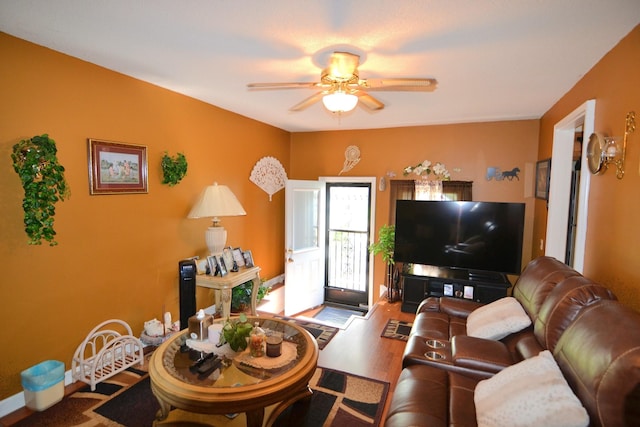 living room with wood finished floors and ceiling fan