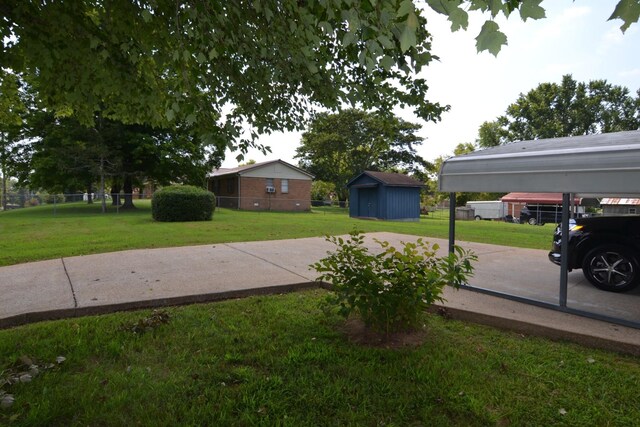 view of yard with an outdoor structure, a storage unit, and fence