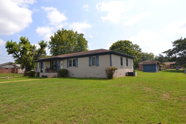 ranch-style home featuring a front lawn, cooling unit, brick siding, and crawl space