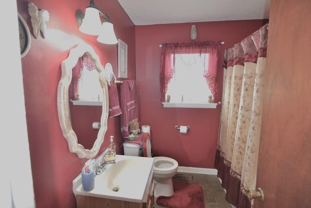 full bath featuring tile patterned floors, baseboards, toilet, and vanity