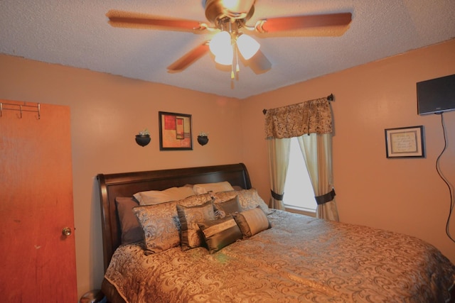 bedroom with a textured ceiling and a ceiling fan