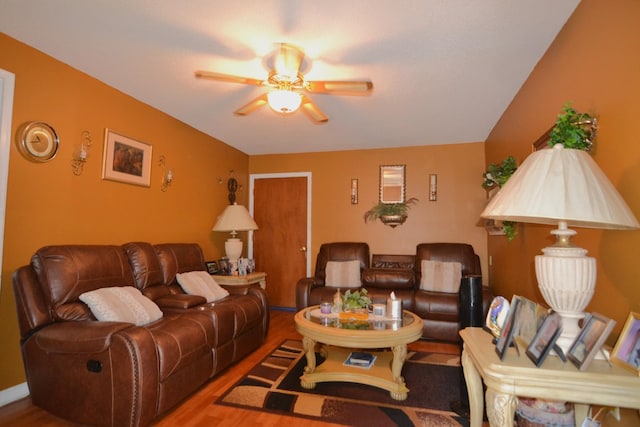 living room featuring a ceiling fan and wood finished floors