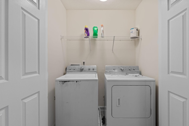 clothes washing area with washing machine and dryer and laundry area