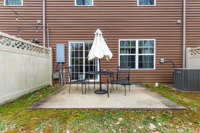 view of patio with fence and central AC