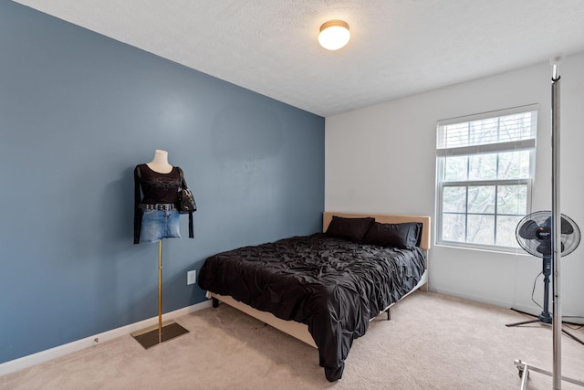 carpeted bedroom featuring visible vents, baseboards, and a textured ceiling