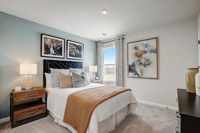 bedroom with visible vents, light colored carpet, and baseboards