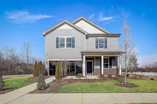 craftsman inspired home with board and batten siding and a front lawn