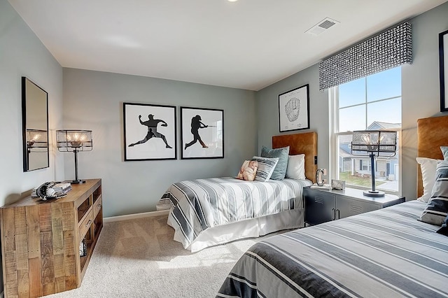 carpeted bedroom featuring visible vents and baseboards