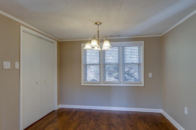 unfurnished dining area featuring dark wood finished floors, crown molding, visible vents, and a chandelier